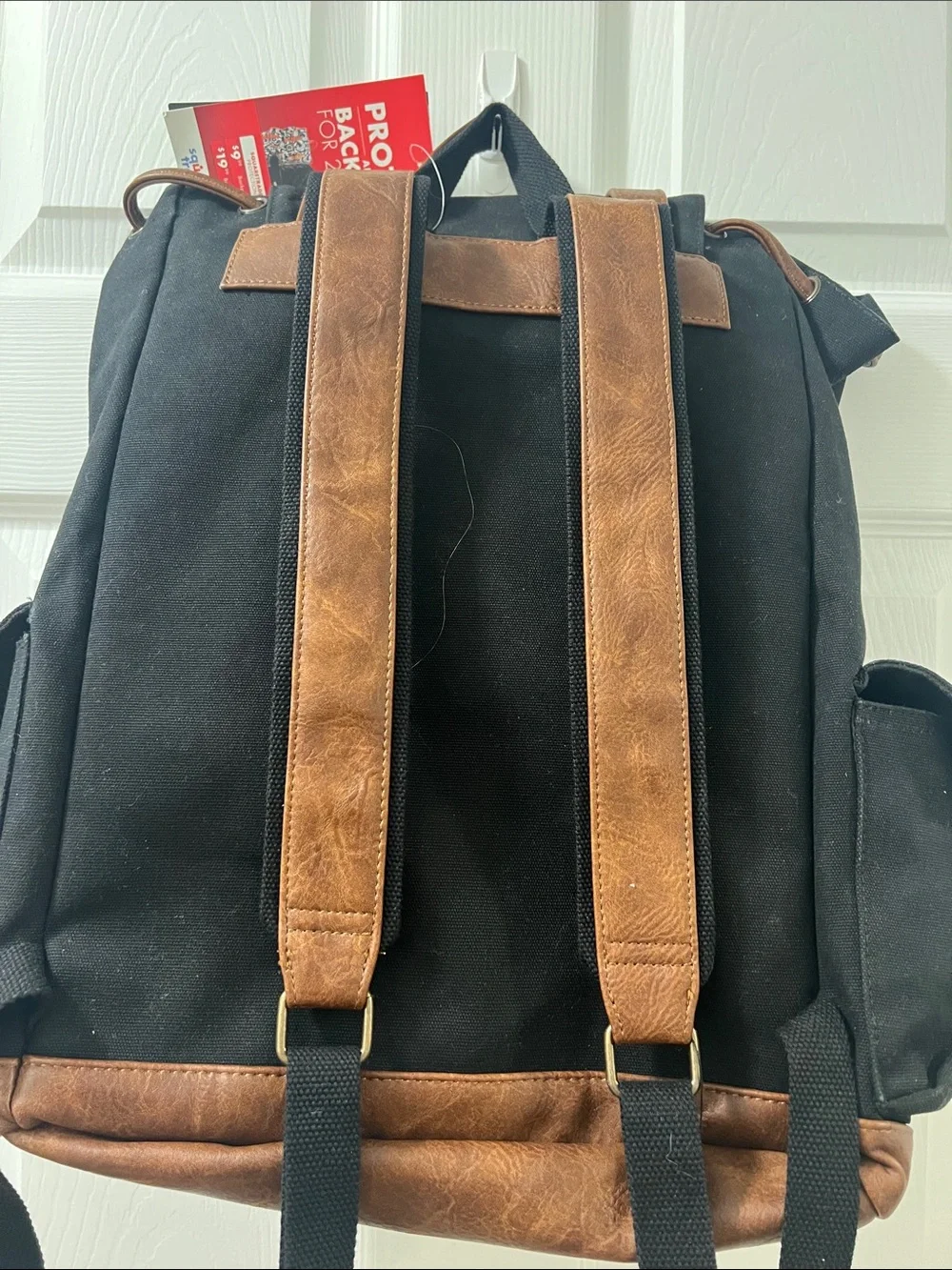 Vintage-Style Black Canvas Backpack with Brown Trim